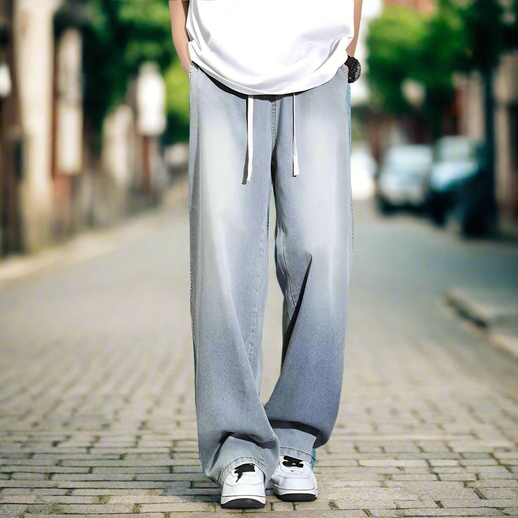 Person wearing light blue jeans and white sneakers on a old style street