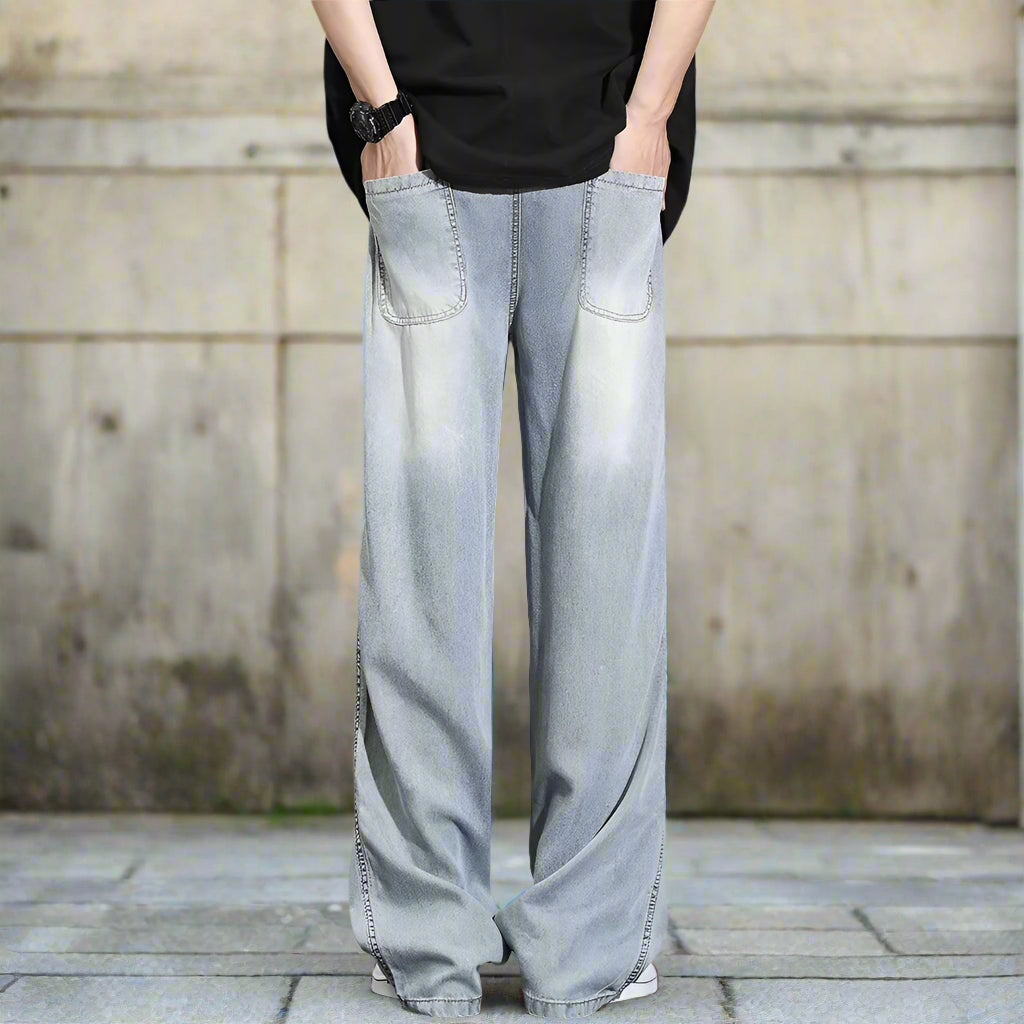 Light blue denim wide-leg pants worn by a person on a gray background