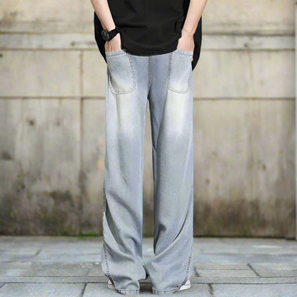 Light blue denim wide-leg pants worn by a person on a gray background