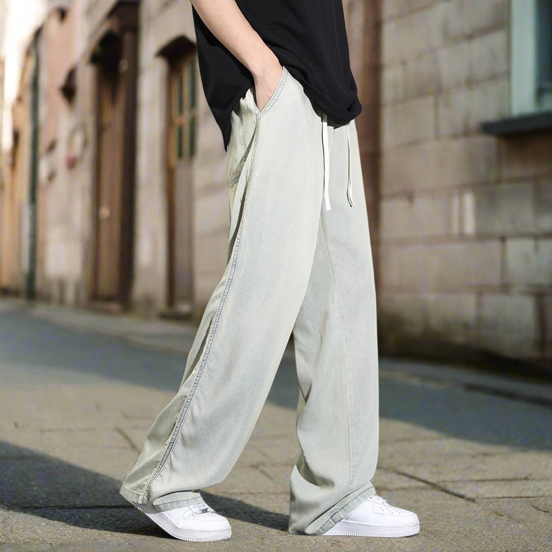 Light-colored wide-leg pants worn by a person on a gray background